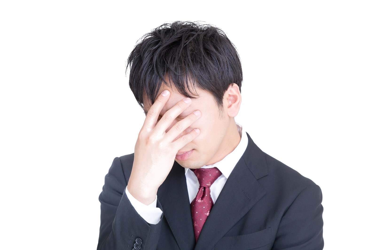 手で顔を覆って落ち込む男性